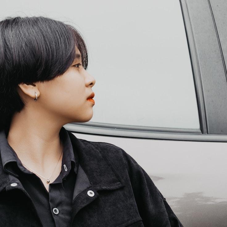 Avery Chen, Lead Design Curator at PrimeVividMarket, reviewing corporate floral arrangements